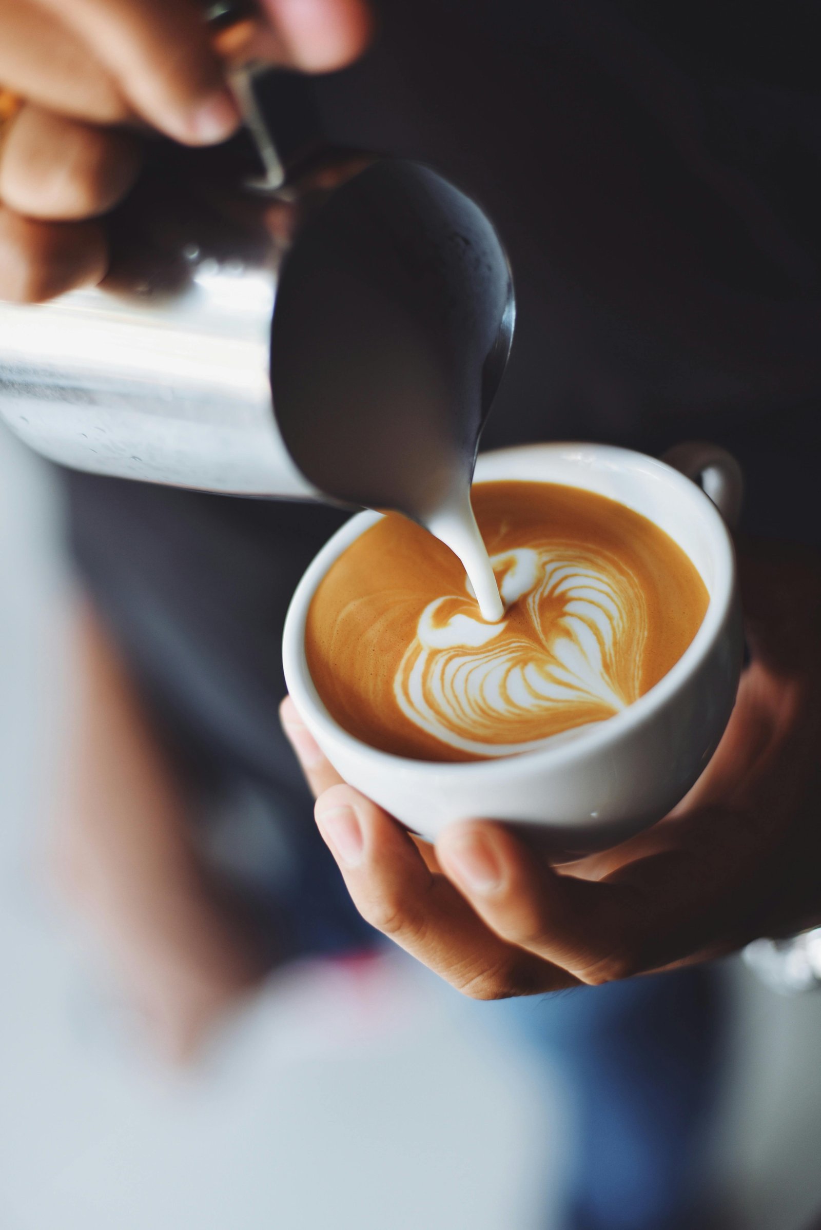 Close up of coffee beans with a cup of latte art